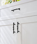 Heavy Duty Black Tree Branch Cabinet Pulls on white kitchen cupboards showcasing rustic twig design and durable zinc alloy material.
