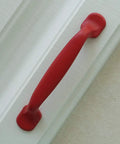 Hella Durable Zinc Alloy Drawer Knobs And Kitchen Cabinet Handles Built Tough For Daily Use Featuring Easy Grip Pulls For Dressers And Kids Furniture Hardware In Totally Dope Colors, red handle on a white surface.