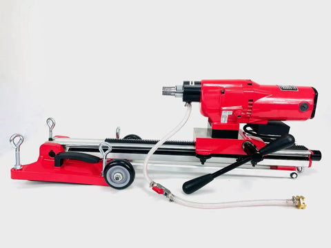 Straight Shooting Heavy Duty Workhorse Diamond Coring Drill With Tilting Rolling Base And Killer 12 Piece Wet Core Bit Set Pro Concrete Cutting Setup 110 Volt with red and silver colors.