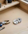 Concealed Cabinet Hinges 90 Degree Flip Adjustable Four Pack Zinc Alloy Flush Mounted on a workbench with tools