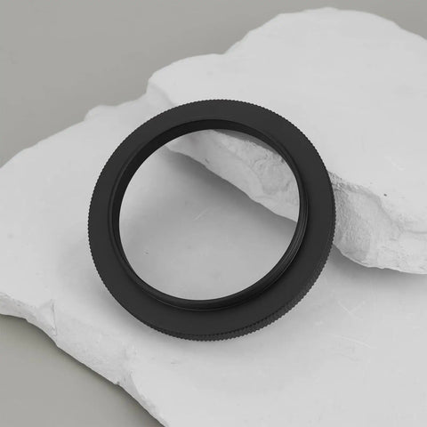 M48 To M54 Telescope Thread Conversion Adapter for Photography Lenses on white surface, black anodized aluminum ring
