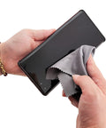 Xthel microfiber eyeglass cleaning cloth front view wiping smartphone screen; gray fabric