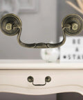 Set Of 6 Antique Bail Handle Drop Pulls With Screws In Vintage Bronze on white cabinet, 3.3 inch hole centers, 4.4 inch total length