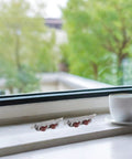 Premium Stainless Steel Sliding Window Rollers And Door Pulleys Featuring Double Wheel Bearings For Hella Smooth Gliding And No Sweat Heavy Duty Hardware Replacement 4 Pack on a window sill.