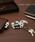 Compact Metal Multitool Card With Screwdriver And Bottle Opener displayed with wallet and keys on a wooden desk