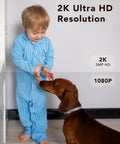 Child in pajamas greeting a dog, showcasing 2K Ultra HD resolution from security camera, ideal for monitoring indoors.