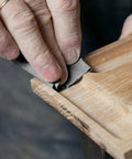 Hand using 20 Sheets 9x3.6 Inch Dry And Wet Sandpaper Kit With Silicon Carbide For Metal And Woodworking Projects on wood