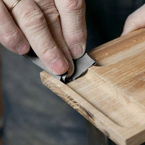 Hand using 20 Sheets 9x3.6 Inch Dry And Wet Sandpaper Kit With Silicon Carbide For Metal And Woodworking Projects on wood