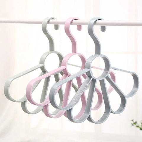 Fan Shaped Closet Rod Organizer For Ties Scarves And Hats Made From Sturdy Polypropylene hanging in light colors.