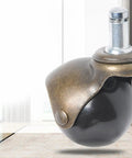 Top Shelf 4 Pack 2 Inch Antique Bronze Swivel Caster Wheels Slick Glide Furniture Rollerballs close-up view of a caster wheel.