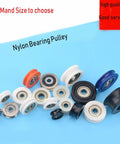 Various sizes of Rock Solid 5 Pack Nylon Pulley Wheels With Quiet Ball Bearings For U Groove Tracks shown on blue background.