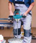 Person using Powerful 2100W Portable Concrete Mixer With Six Speed Settings, Handheld Cement Mixer for mortar.