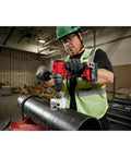 Man using Half Inch Compact Cordless Drill Driver Kit Featuring Rock Solid Metal Chuck And Carbide Teeth on metal pipe.