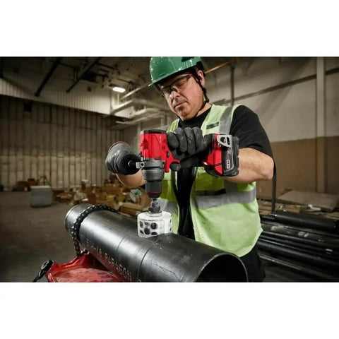 Man using Half Inch Compact Cordless Drill Driver Kit Featuring Rock Solid Metal Chuck And Carbide Teeth on metal pipe.