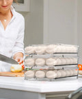 Auto Rolling Egg Holder For Refrigerator Two-Layer 36 Egg Capacity with eggs and woman chopping vegetables in kitchen