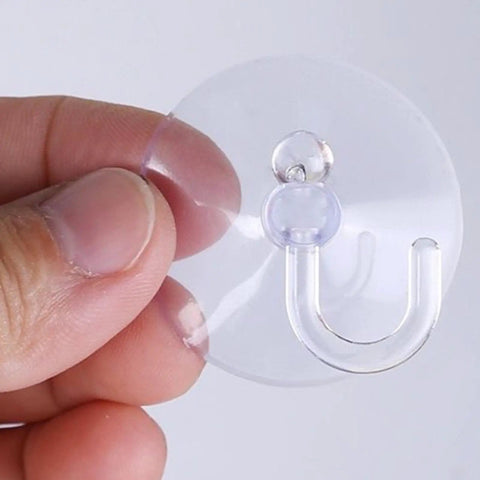 Super Strong Suction Cup Hooks For Bathroom Wall 10 Pack held in hand showing clear resin design for easy hanging.