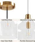 Close-up of Hand Blown Glass Bell Pendant Light in Gold and Clear, Industrial Farmhouse Style, showing gold base and clear shade.
