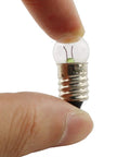Hella Bright E10 Mini Light Bulbs 10 Pack Screw Base Indicator Lamps With Rock Solid Filament And Smooth Incandescent Glass Build held in hand.
