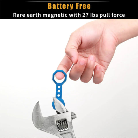 Hand holding blue keychain accessory with No Sweat Heavy Duty Magnetic Stud Finder Wall Scanner near adjustable wrench.