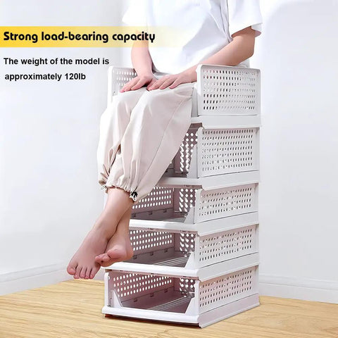 Person seated on Five Pack Stackable Closet Storage Boxes With Lids, Durable Plastic Drawer Organizers, showing load-bearing capacity.