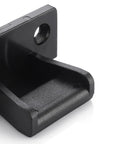 Close-up of heavy duty concealed panel fastener for kitchens, black plastic, designed for secure snap lock mounting.
