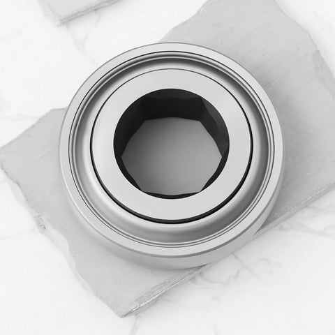 Tough As Nails Rock Solid Hex Bearing 210RRB6 One Inch Half X Ninety Millimeter Heavy Duty Replacement For John Deere Farm Tractors, silver hex bearing on a stone background.