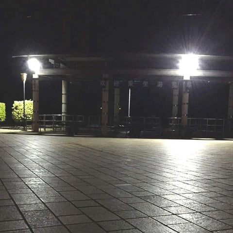 Solid Solar Flood Light With A Kickin Brightness Setup And Zero Sweat Weather Proofing illuminating a tiled patio at night.