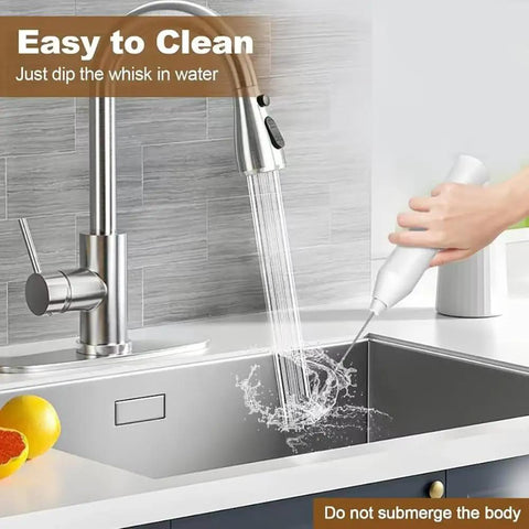 Person cleaning the rechargeable handheld milk frother with two stainless steel whisk heads under a kitchen sink tap.
