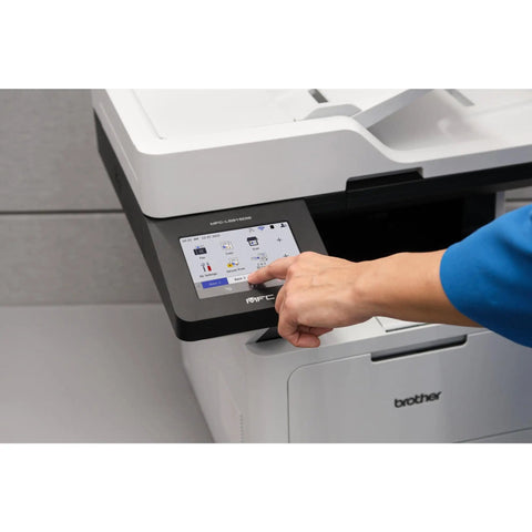 Hand using touchscreen on Professional Monochrome Laser All In One Printer With Scanner And Copier Lightning Fast 50 Ppm Printing Wireless Network Ready With Dual Band WiFi Auto Duplex Print For Busy Offices Model MFC L5915DW