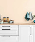 Kitchen scene with Matte Black 10 Inch Square Cabinet Pulls, 5 Pack on white cabinets, showcasing modern hardware for homes and offices
