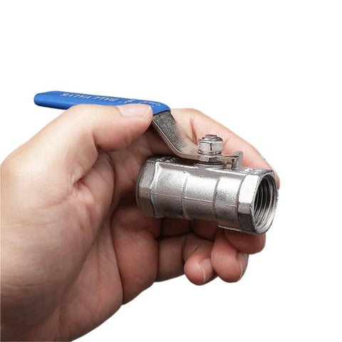 Bulletproof Stainless Steel Ball Valve With Slick Female Threaded Plumbing Connector For Faucets And Water Pipes held in hand.