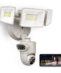 Tough As Nails Outdoor Security Camera Featuring Dual Lens Design With Three Sixty Auto Tracking Heavy Duty Floodlight Setup Four Megapixel Clarity with mounted grey housing and dual LED floodlights.