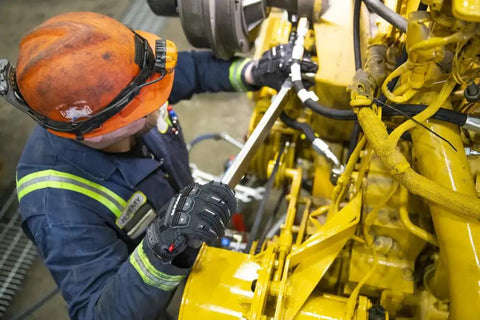 Worker using Winter Ready Insulated Work Gloves with Impact Protection while handling machinery, showing heavy duty grip