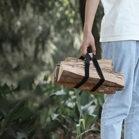 Person carrying firewood secured with 4 Pack Heavy Duty Luggage Tie Straps Featuring Swivel Hog Ring Hooks For Roof Rack Cargo And Truck Bed Hauling Secure Your Gear With Zero Sweat On Long Drives.