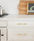 10 Pack 5 Inch Brushed Gold Cabinet Pulls Heavy Duty Zinc Alloy Drawer Handles For Kitchen Cupboards And Dressers, installed on white drawers.