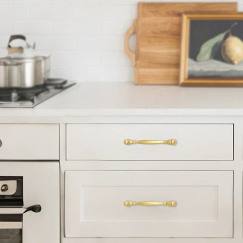 10 Pack 5 Inch Brushed Gold Cabinet Pulls Heavy Duty Zinc Alloy Drawer Handles For Kitchen Cupboards And Dressers, installed on white drawers.