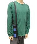 Person wearing green shirt with a bottle strapped in a blue holder over shoulder.