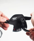 Close-up of right hand 9 speed trigger shifter lever for Shimano and SRAM bikes thumb button upshift and downshift mechanism.