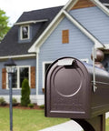 Northpointe Large Capacity Post Mount Mailbox in galvanized steel with Venetian Bronze finish in front of a suburban home