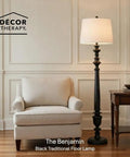 Benjamin Traditional Floor Lamp Satin Black Finish With Resin Construction next to a beige armchair and side table in living room.