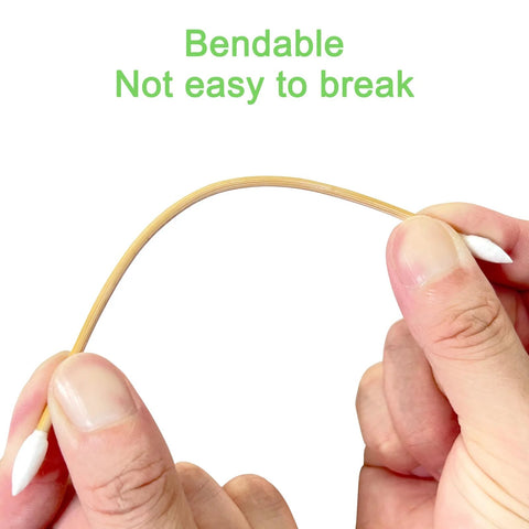 Close-up of a double-ended 6-inch bamboo gun-cleaning cotton swab with pointed tips, held between fingers
