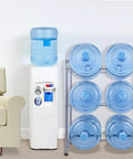 Heavy Duty 3 Tier Water Jug Rack For 5 Gallon Jugs next to water cooler in home office.