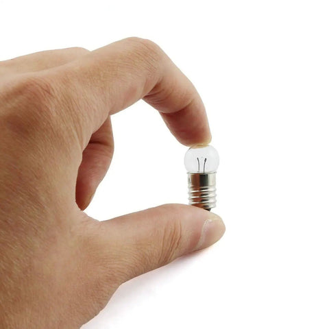 Heavy Duty E10 Miniature Screw Base Light Bulbs 1.5 Volt 0.3 Amp Pack Of Twenty Five held in hand, showcasing size and detail.