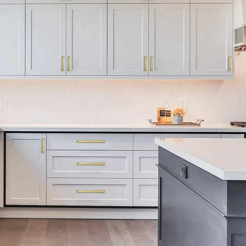Premium Brushed Gold Drawer Pulls 10 Pack 5 Inch Cabinet Handles on modern kitchen cabinets with gray finish.