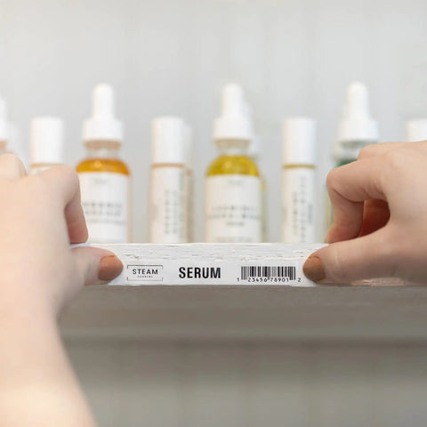 Hands holding a shelf labeled 'Serum' with the P Touch PT D610BT Label Maker With Bluetooth And USB Pro Grade Connected Label Printer.