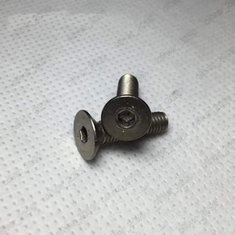 Premium Titanium Gr2 Countersunk Flat Head Screws With Hex Socket Drive Metric Fine Thread Machine Bolts Built Tough As Nails For Demanding Projects And Heavy Shop Work M3 0.5 X 40Mm Bulk Pack Five on a textured background.