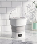 Compact Folding Mini Washing Machine Portable Laundry Basin with handle for easy travel and dorm use.