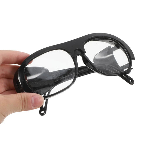 Six Piece Heavy Duty Welding Safety Glasses Ironclad Brazing Eyewear Blocks Sparks Fumes And Flying Debris With Rugged Durable Plastic held in hand