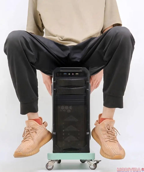Mobile Heavy Duty Rolling Computer Tower Stand With Lockable Swivel Casters And Smart Cooling For Slick Under Desk Moves Secure Pro Black Steel Desktop Rig Cart positioned under a person.