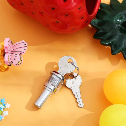 Universal Gumball Machine Keys Replacement for Secure Cylinder Lock with durable metal and plastic build on yellow surface